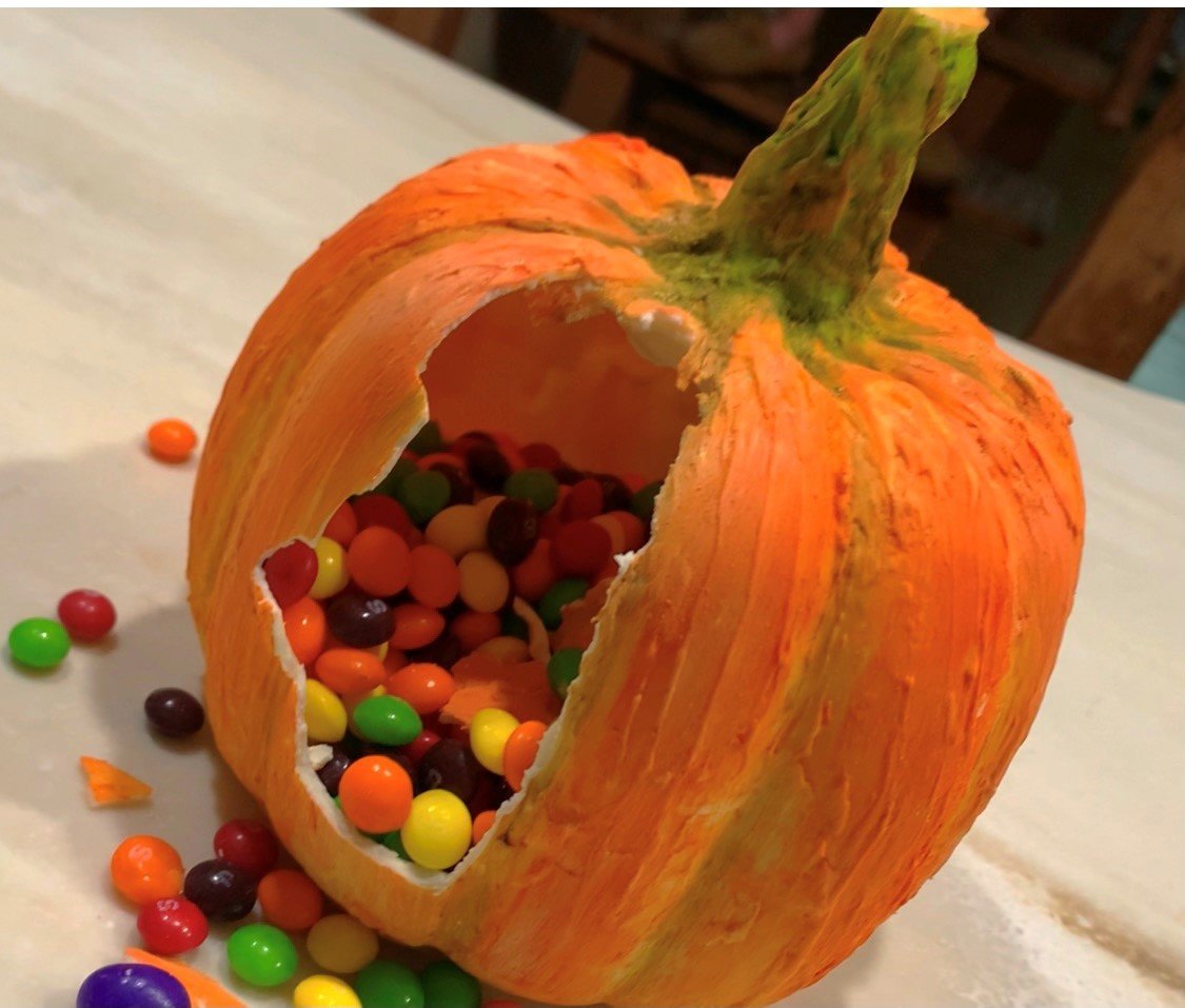 Surprise candy pours out of the chocolate pumpkin.